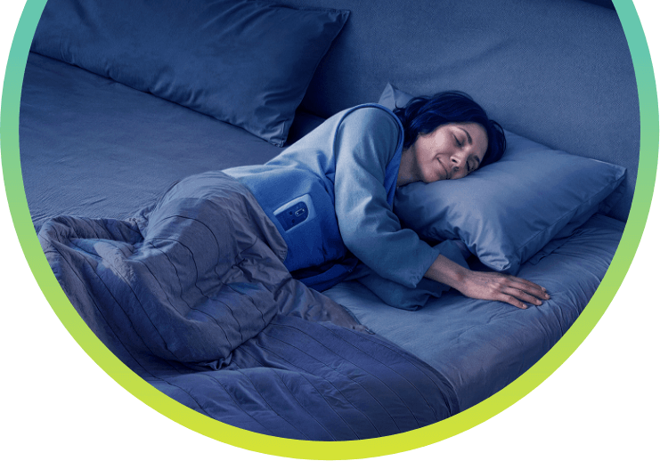 A woman laying in bed wearing her VYALEV™ pump.
